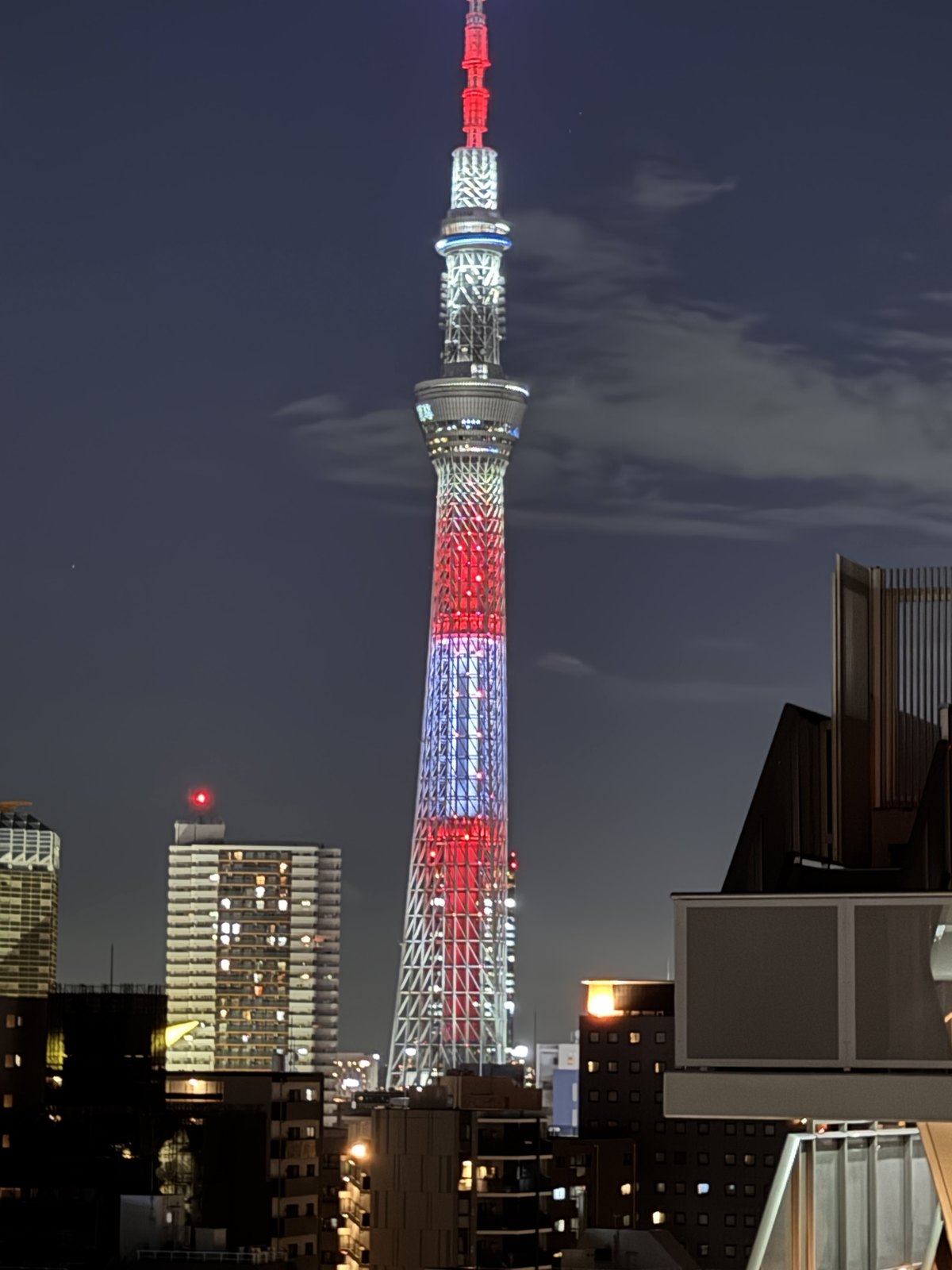 Tokyo Skytree lit up at night, seen from a hotel roof terrace in Asakusa
