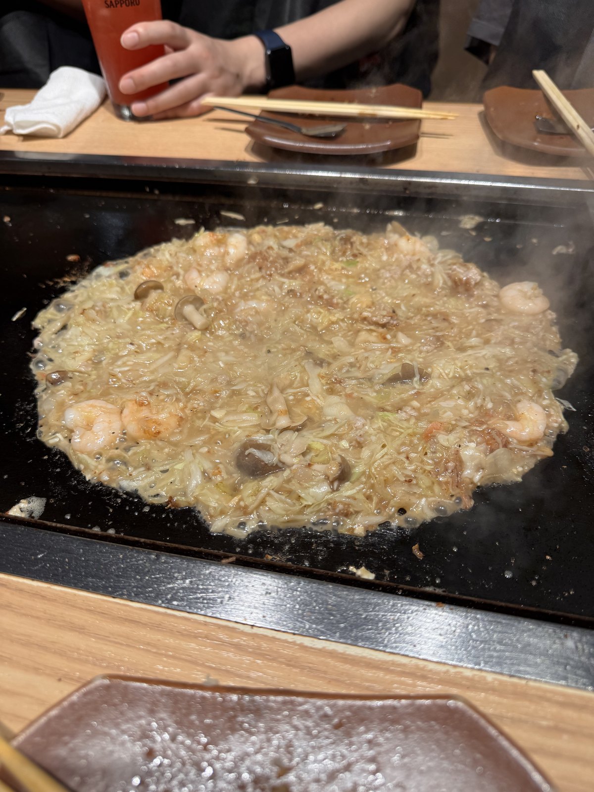 Monjayaki batter poured into the well in the ring of cabbage
