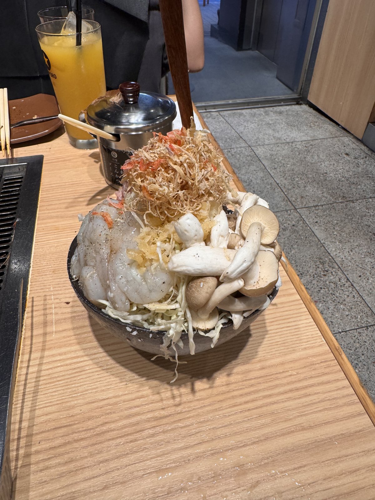 Monjayaki being cooked on the griddle at a restaurant in Tsukishima
